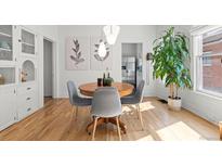 Dining room featuring hardwood floors, modern lighting, and built in shelving at 3384 W 29Th Ave, Denver, CO 80211