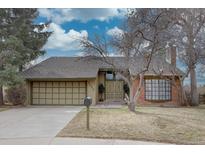 Charming single-Gathering home featuring a two-car garage and lush landscaping, perfect for suburban living at 7690 S Uinta Ct, Centennial, CO 80112