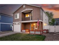 Charming two-story home featuring a balcony, well-kept lawn, and inviting curb appeal at 4705 Andes St, Denver, CO 80249