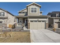 Charming two-story home with a two car garage, a covered porch and beautiful stone accents at 13261 E 110Th Pl, Commerce City, CO 80022