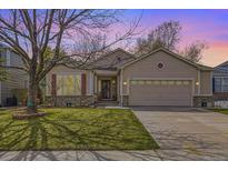 Charming single-Gathering home with well-maintained lawn, two-car garage, and lovely landscaping details at 2556 E 131St Pl, Thornton, CO 80241