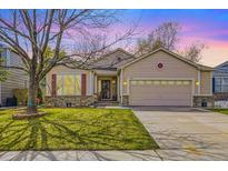 Charming single-story home featuring a well-manicured lawn, mature trees, and an attached two-car garage at 2556 E 131St Pl, Thornton, CO 80241