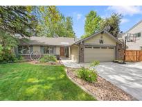 Charming ranch-style home with a well-manicured lawn, mature trees, and a two-car garage at 5050 W 102Nd Ave, Westminster, CO 80031