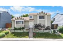 Charming two-story home with a well-maintained lawn and landscaped garden, enhanced by a neatly stepped walkway at 113 Rockaway Ave, Castle Rock, CO 80104