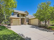 Inviting exterior of a two-story home featuring a three-car garage and stone accents at 24487 E Frost Dr, Aurora, CO 80016