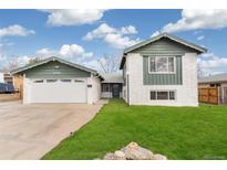 Charming exterior view of a two-story home with a well-maintained lawn and attached garage at 6190 Garrison St, Arvada, CO 80004