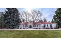 Stunning single-story home with manicured lawn, red tile roof, and arched windows at 4 Cherry Hills Farm Dr, Cherry Hills Village, CO 80113