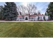 Expansive estate exhibits a circular driveway, mature landscaping, and stucco exterior with tile roof at 4 Cherry Hills Farm Dr, Englewood, CO 80113