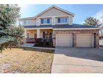Charming two-story home with a brick facade, covered porch, and a well-manicured lawn at 1146 W 144Th Pl, Westminster, CO 80023