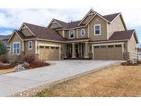 Front exterior of a two-story home with stone accents and three-car garage at 3392 Homestead Dr, Longmont, CO 80504