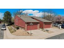 Charming townhome featuring attached garages, well-maintained landscaping, and a welcoming facade at 2812 W Davies Dr, Littleton, CO 80120