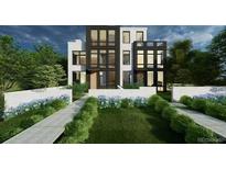 Stunning modern home featuring a black and white exterior, large windows and a meticulously landscaped front yard at 203 Garfield St, Denver, CO 80206