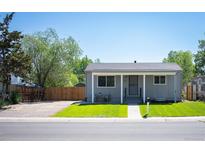 Charming single-story home with a well-maintained lawn and inviting front porch at 7870 Magnolia St, Commerce City, CO 80022