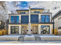 Modern two-story duplex with stone facade, large windows, and rooftop balconies at 372 S Humboldt St, Denver, CO 80209