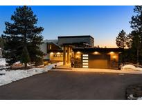 Stunning modern home with sleek architectural lines, a porte-cochere, and a well-lit two-car garage at 367 Sandy Hollow Trl, Franktown, CO 80116
