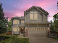 Charming two-story home with a well-manicured lawn and a two-car garage showcasing great curb appeal at 7659 Lebrun Ct, Lone Tree, CO 80124