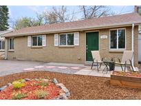Charming brick home with a well-maintained front yard and outdoor seating at 3715 Wolff St, Denver, CO 80212