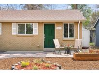 Charming brick home featuring a well-maintained front yard with planters and a cozy seating area near the entrance at 3715 Wolff St, Denver, CO 80212
