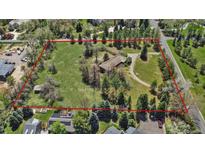 Expansive lot with a home surrounded by lush greenery and mature trees, outlined in red for property lines at 4480 S Franklin St, Cherry Hills Village, CO 80113