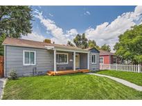 Charming single-story home with a well-maintained lawn and welcoming front porch at 1309 Jamaica St, Aurora, CO 80010