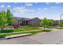 Charming single Gathering home with manicured front lawn and two car garage at 22656 E Glidden Dr, Aurora, CO 80016