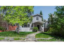 Charming two-story home featuring a welcoming front porch, well-maintained lawn, and attractive stone pathway to the front door at 1835 Columbine Ave, Boulder, CO 80302