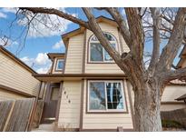 Charming two-story home with neutral siding, brown trim, and a large tree in the front yard at 1816 S Pagosa Way # 5, Aurora, CO 80017