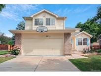 Charming two-story home featuring a two-car garage with a basketball hoop, and manicured landscaping at 3575 W Hamilton Pl, Denver, CO 80236