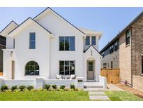 Beautiful white brick home with manicured lawn and charming front porch, perfect for relaxing and enjoying the neighborhood at 4131 Quivas St, Denver, CO 80211