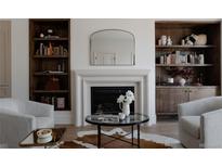 Cozy living room featuring built-in bookshelves, a fireplace, and stylish decor at 4131 Quivas St, Denver, CO 80211