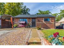 Charming brick home featuring a well-manicured lawn, covered porch, and a cozy swing at 1591 S Zuni St, Denver, CO 80223