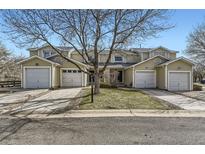 Charming townhome with attached garages, well-maintained landscaping, and mature tree at 7822 S Kittredge Cir, Englewood, CO 80112