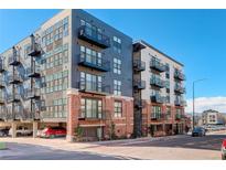 Modern multi-story apartment building with brick facade and private balconies at 3500 S Corona St # 205, Englewood, CO 80113