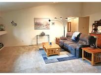 Spacious living room featuring plush carpeting, comfortable seating, and natural light at 5860 W 115Th Ave, Westminster, CO 80020