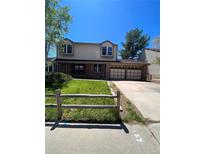 Charming two-story home with a well-manicured lawn and inviting curb appeal at 10064 W Lake Dr, Littleton, CO 80127
