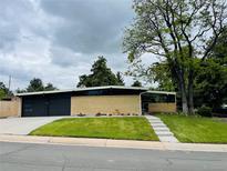 Charming single-story home with a well-maintained lawn and a modern design at 6068 S Clayton St, Centennial, CO 80121