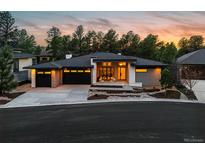 Stunning exterior view of a modern home with a three-car garage and beautiful landscaping at 2580 Saddleback Dr, Castle Rock, CO 80104