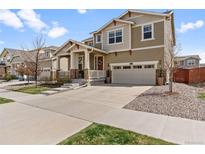 Charming two-story home featuring a front porch, two-car garage, and well-maintained landscaping at 14938 Vienna Cir, Parker, CO 80134