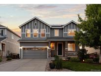 Charming two-story home with a gray exterior, well-maintained lawn, and a two-car garage at 7536 Grady Cir, Castle Rock, CO 80108
