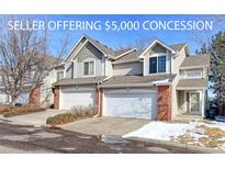 Charming townhouse with a two-car garage, brick accents, and well-maintained landscaping in a desirable neighborhood at 13068 Harrison Dr, Thornton, CO 80241