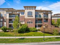 Stunning multi-story condo building with brick and neutral siding, balconies, and well-maintained landscaping at 3865 S Dayton St # 105, Aurora, CO 80014