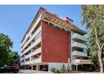 An exterior daytime view of this condo building from the street at 937 Clarkson St # 101, Denver, CO 80218