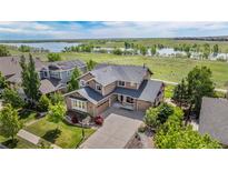 Beautiful two-story home featuring a three-car garage, basketball hoop, and lovely front yard landscaping at 26741 E Arbor Dr, Aurora, CO 80016