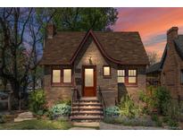 Charming brick home with a cozy front porch and landscaped yard, perfect for enjoying peaceful evenings at 1601 Albion St, Denver, CO 80220