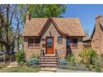 Charming brick home with unique roofline, inviting front steps, and manicured landscaping at 1601 Albion St, Denver, CO 80220