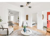 Bright and open living space with hardwood floors, offering views of the dining room and bedroom for seamless living at 230 E Ellsworth Ave, Denver, CO 80209