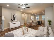 Open-concept living area with hardwood floors, modern furnishings, and a stylish dining area adjacent to the kitchen at 630 E Hinsdale Ave, Littleton, CO 80122