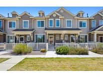 Charming townhome with a well-manicured lawn and white picket fence, offering curb appeal at 16285 W 62Nd Ln # C, Arvada, CO 80403