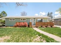 Charming green ranch-style house featuring a well-manicured lawn and a welcoming front porch with wooden accents at 1662 S Eudora St, Denver, CO 80222