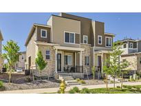 Charming townhome with brick and siding, featuring a cozy front porch and well-maintained landscaping at 24374 E 42Nd Ave, Aurora, CO 80019